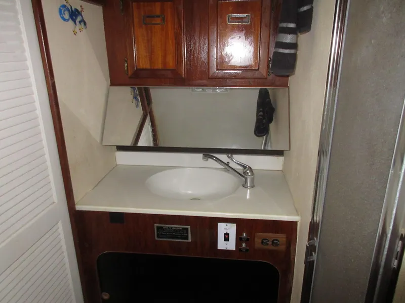 Slide: The Image of 1978 Pacemaker 40 Sport Fish bathroom sink with mirror and wooden cabinets. - 29