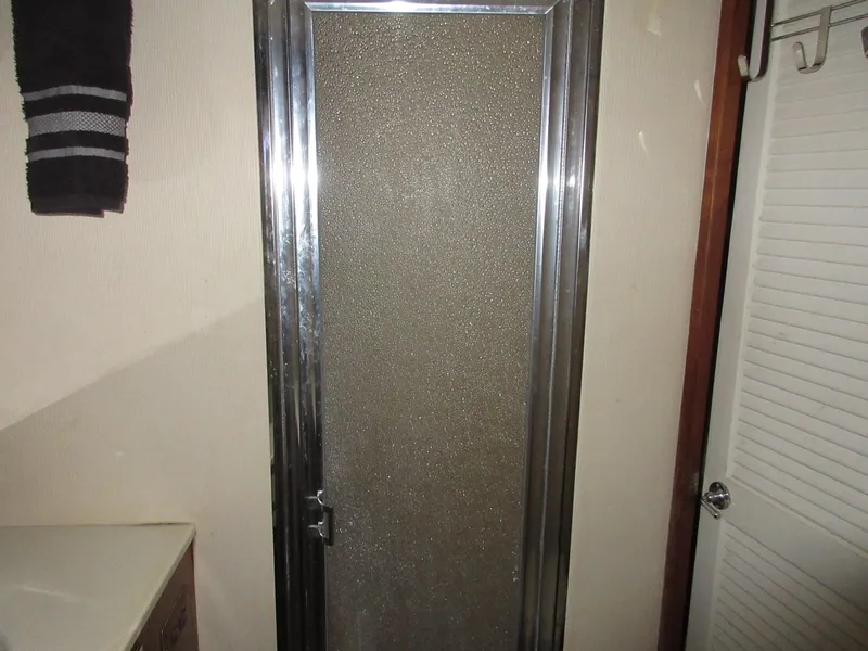 Slide: The Image of 1978 Pacemaker 40 Sport Fish bathroom with frosted glass shower door. - 30
