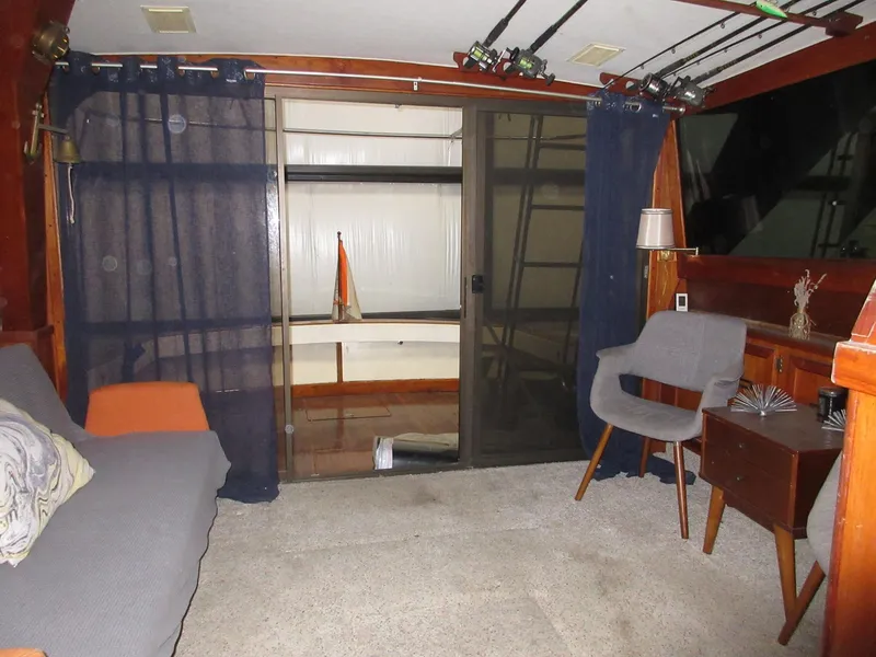 Slide: The Image of Interior of a 1978 Pacemaker 40 Sport Fish boat with seating and fishing rods. - 31