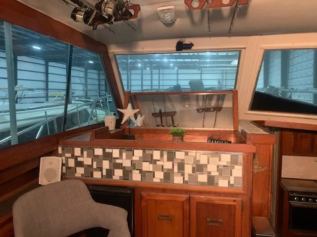 Slide: The Image of Interior of a 1978 Pacemaker 40 Sport Fish boat with wooden cabinetry and tiled backsplash. - 32