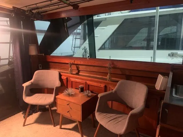 Slide: The Image of Interior of 1978 Pacemaker 40 Sport Fish with modern chairs and wooden decor. - 34