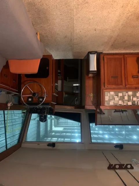 Slide: The Image of Interior of a 1978 Pacemaker 40 Sport Fish boat with wooden cabinetry and steering wheel. - 37