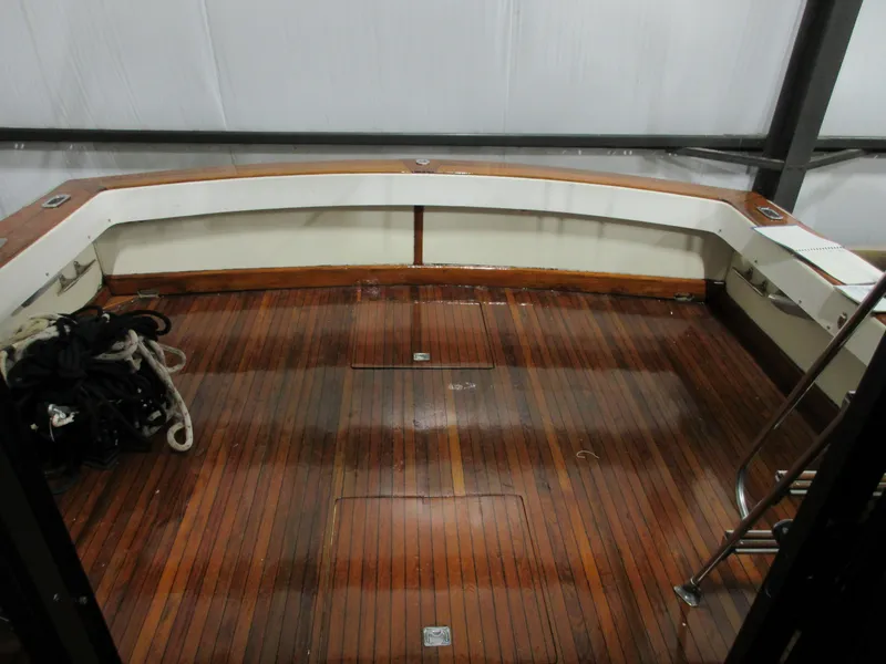 Slide: The Image of 1978 Pacemaker 40 Sport Fish boat deck with wooden flooring and seating. - 4