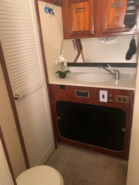Slide: The Image of 1978 Pacemaker 40 Sport Fish boat bathroom with sink and storage cabinets. - 41