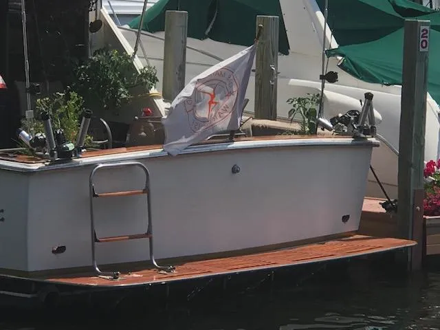 Slide: The Image of 1978 Pacemaker 40 Sport Fish boat docked with flag and fishing gear. - 5