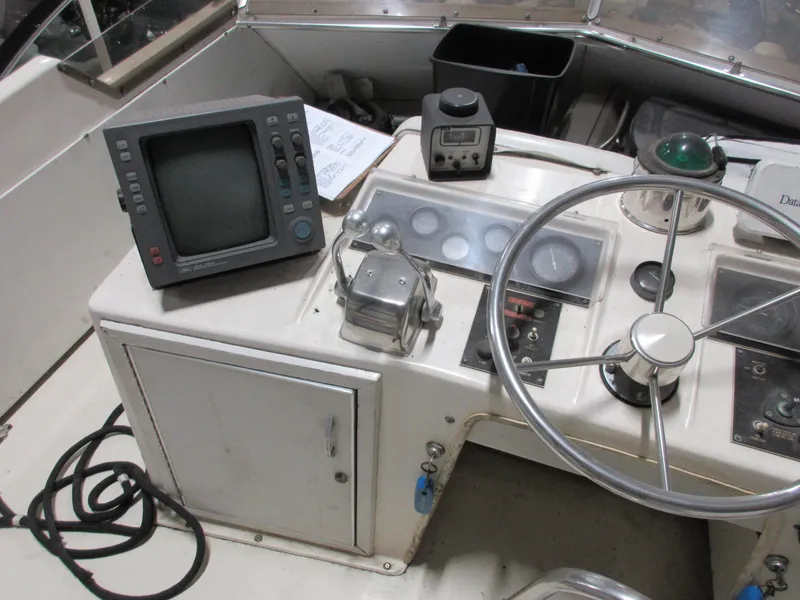 Slide: The Image of 1978 Pacemaker 40 Sport Fish boat helm with navigation equipment and steering wheel. - 7
