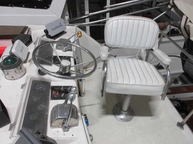 Slide: The Image of 1978 Pacemaker 40 Sport Fish boat helm with white captain's chair and Garmin navigation. - 9