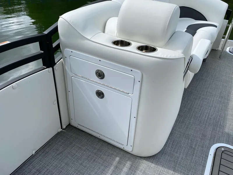 Slide: The Image of 2023 JC Neptoon Sport 23TT boat interior with white seating and storage compartments. - 9