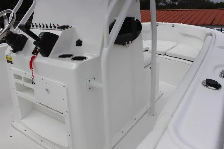 Slide: The Image of 2024 Clearwater 2200 boat interior with steering console and seating area. - 4