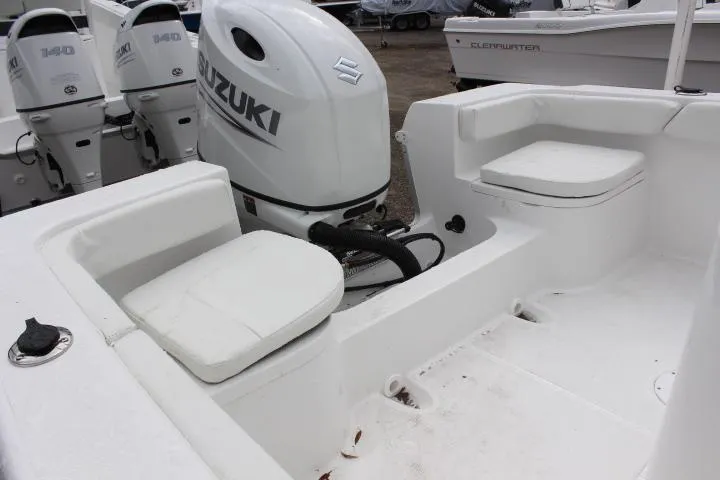 Slide: The Image of 2024 Clearwater 2200 boat with Suzuki outboard motor and seating area. - 5