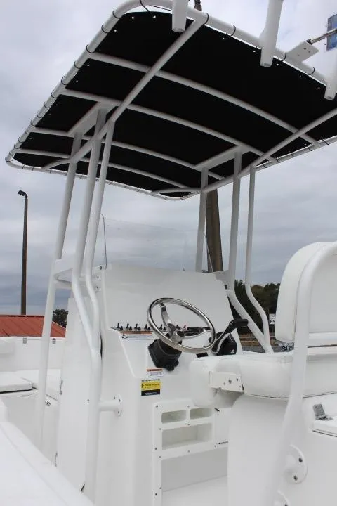 Slide: The Image of 2024 Clearwater 2200 boat console with T-top and steering wheel. - 12