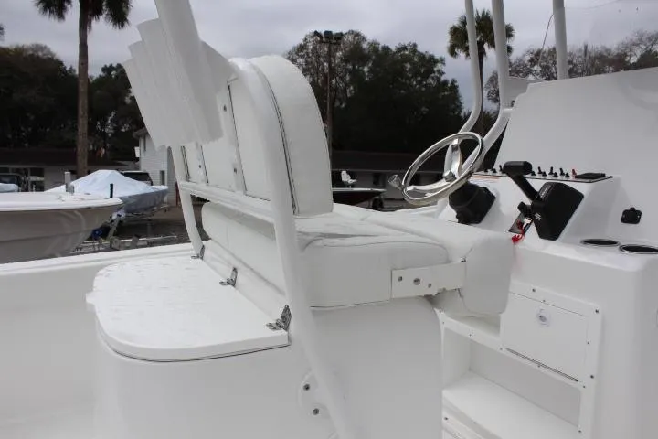 Slide: The Image of 2024 Clearwater 2200 boat interior with white seating and steering console. - 6