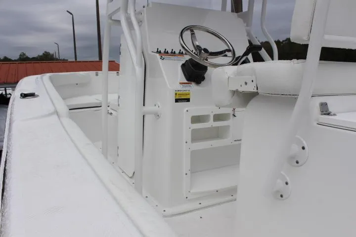 Slide: The Image of 2024 Clearwater 2200 boat interior with steering console and seating. - 7