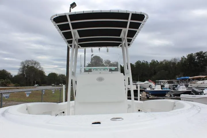 Slide: The Image of 2024 Clearwater 2200 boat with T-top, docked in a marina. - 8