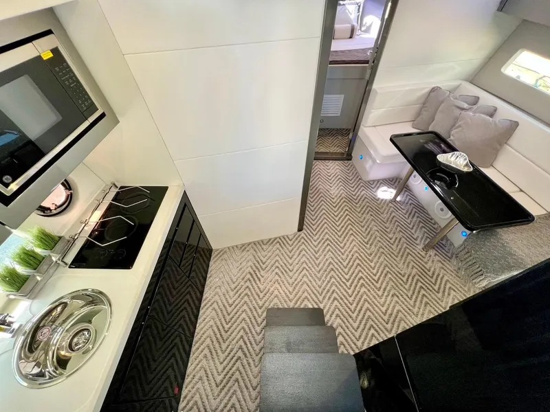 Slide: The Image of Luxurious interior of 2025 Schaefer 400 Sport yacht with modern kitchen and cozy seating area. - 11
