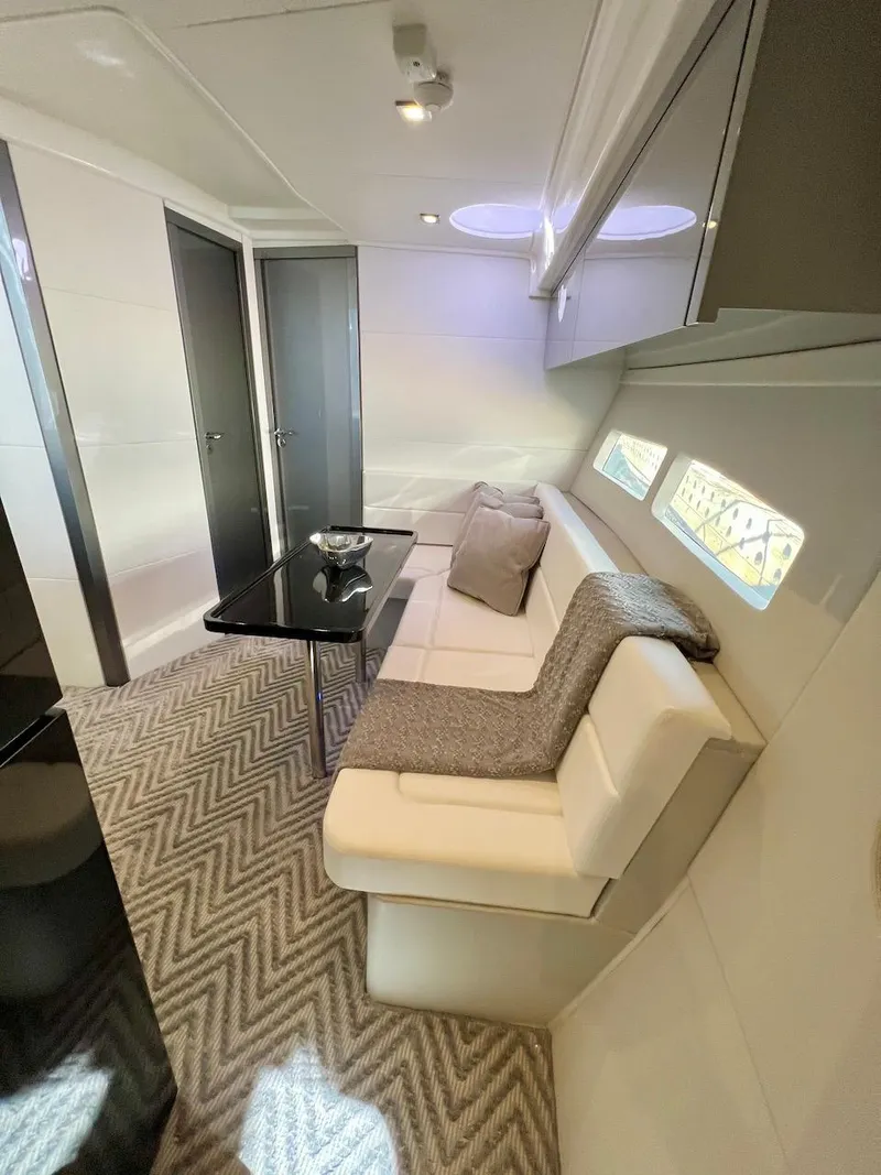 Slide: The Image of Luxurious interior of 2025 Schaefer 400 Sport yacht with modern seating and elegant decor. - 24