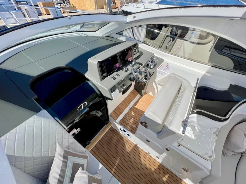 Slide: The Image of Interior of 2025 Schaefer 400 Sport yacht with modern helm and seating. - 28