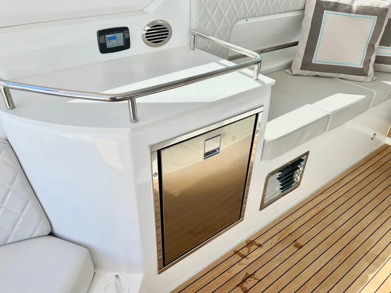 Slide: The Image of 2025 Schaefer 400 Sport yacht interior with cushioned seating and stainless steel accents. - 30
