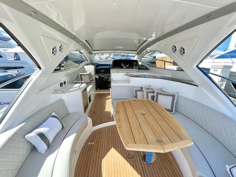 Slide: The Image of Luxurious interior of 2025 Schaefer 400 Sport yacht with elegant seating and wooden table. - 32