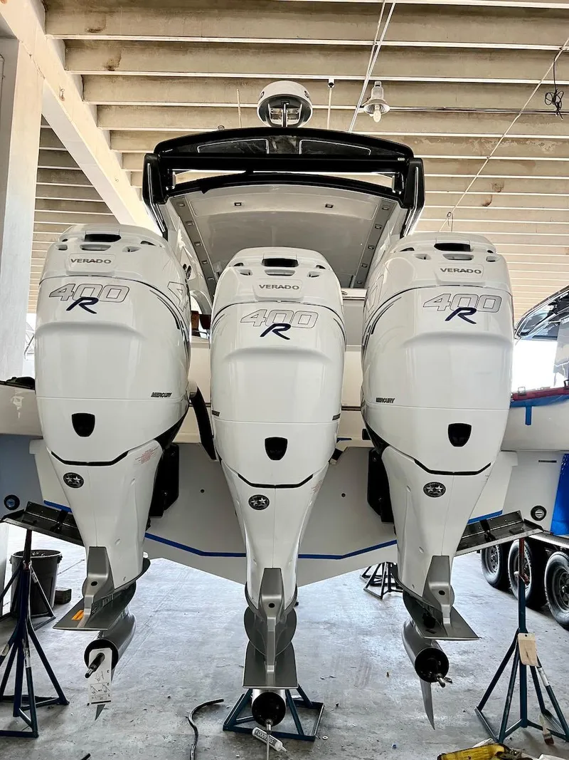 Slide: The Image of 2025 Schaefer 400 Sport boat with triple Mercury Verado 400R engines in a garage. - 43