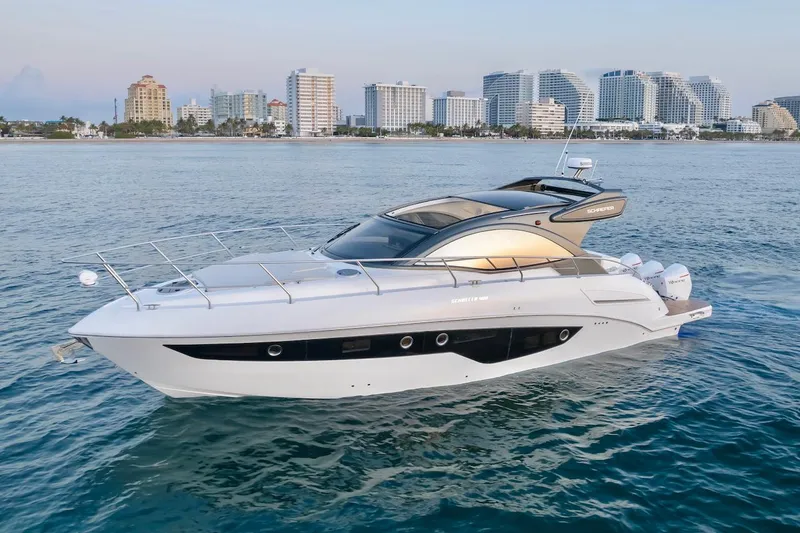 Slide: The Image of 2025 Schaefer 400 Sport yacht cruising near city skyline. - 5