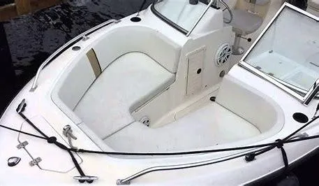 Slide: The Image of 2002 Mako 195 Dual Console boat interior with seating and storage compartments. - 1