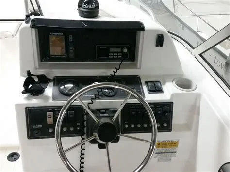 Slide: The Image of Steering console of a 2002 Mako 195 Dual Console boat with navigation equipment. - 3