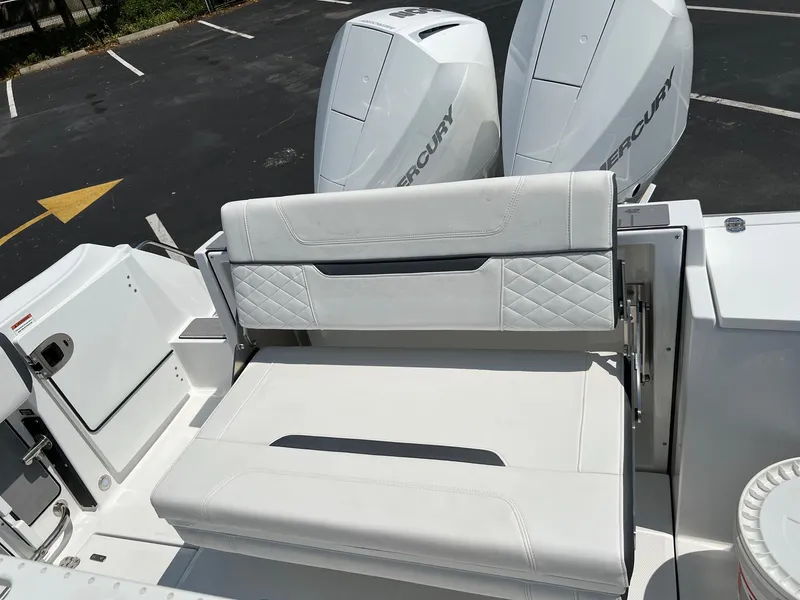 Slide: The Image of 2023 Blackfin 252 CC boat with dual Mercury engines and white seating. - 20