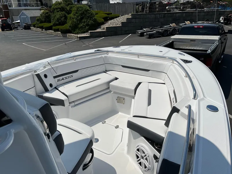 Slide: The Image of 2023 Blackfin 252 CC boat interior with white seating and modern design. - 24