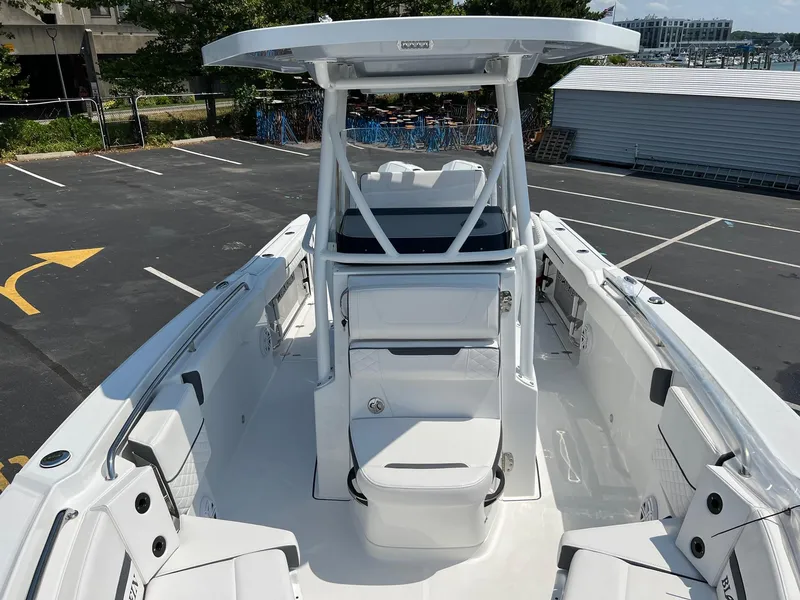 Slide: The Image of 2023 Blackfin 252 CC center console boat in a parking lot. - 26
