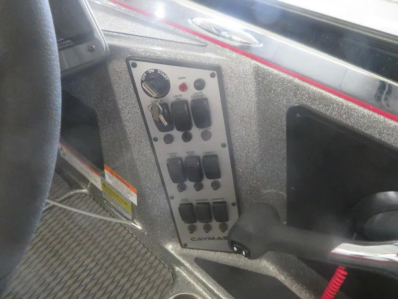 Slide: The Image of Control panel of a 2022 Caymas CX19 boat with ignition and switches. - 4