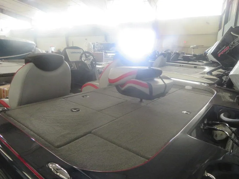 Slide: The Image of 2022 Caymas CX19 boat interior with cushioned seating and storage compartments. - 5