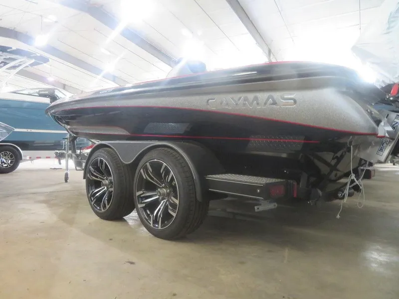 Slide: The Image of 2022 Caymas CX19 boat on a dual-axle trailer in an indoor showroom. - 7