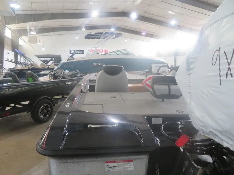 Slide: The Image of 2022 Caymas CX19 boat displayed in a showroom with other boats. - 9