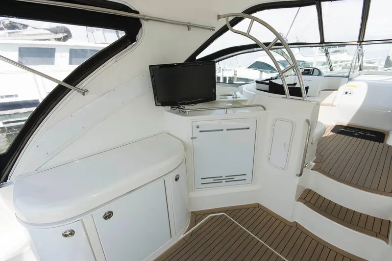 Slide: The Image of Interior of a 2005 Cruisers Yachts 520 Express with TV and stairs. - 13