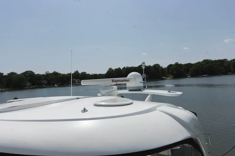 Slide: The Image of 2005 Cruisers Yachts 520 Express on a tranquil lake. - 21