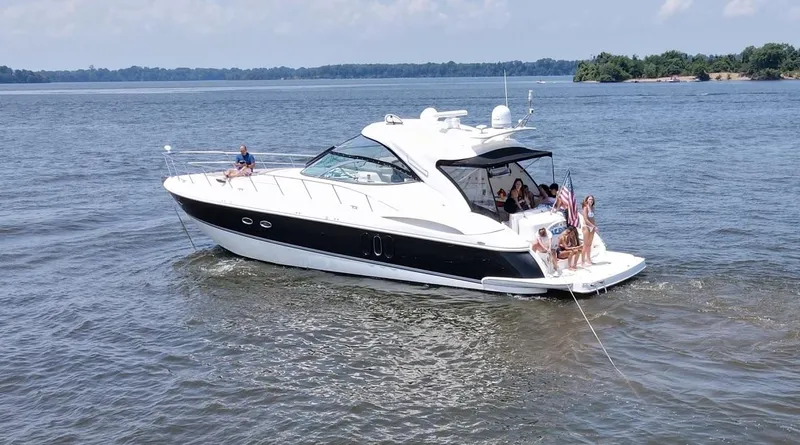 Slide: The Image of 2005 Cruisers Yachts 520 Express on water with passengers. - 4