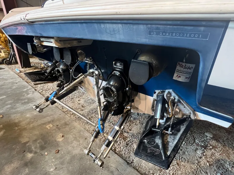 Slide: The Image of 2001 Donzi 38 ZX boat stern with dual outboard motors in a garage setting. - 4