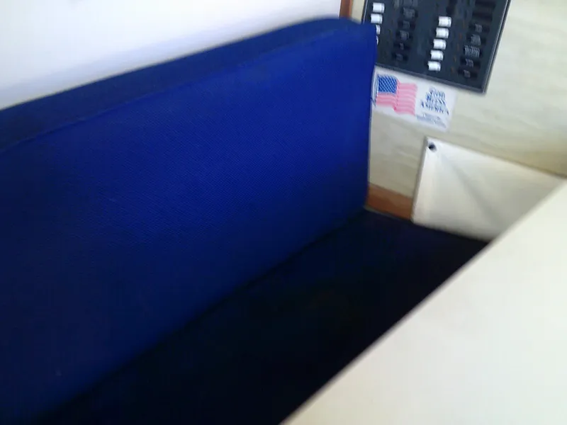 Slide: The Image of Blue seating area in a 1980 Bertram 28 Flybridge Cruiser boat interior. - 18