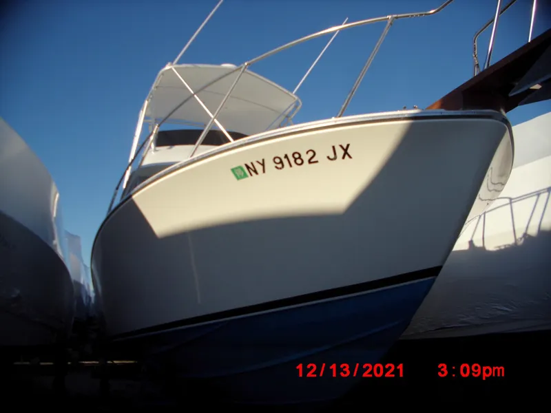 Slide: The Image of 1980 Bertram 28 Flybridge Cruiser boat with NY 9182 JX registration. - 2