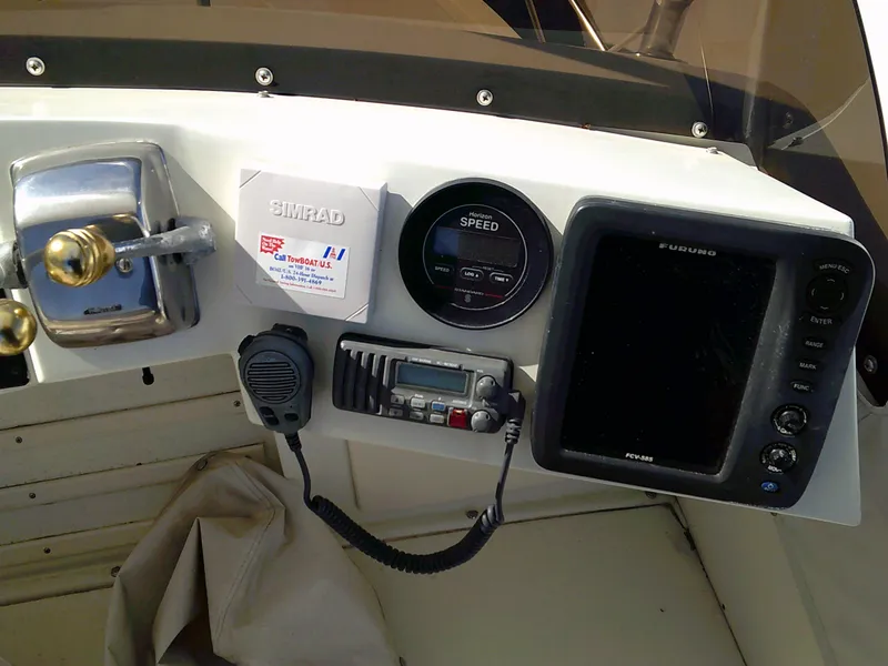 Slide: The Image of 1980 Bertram 28 Flybridge Cruiser helm with navigation and communication equipment. - 20