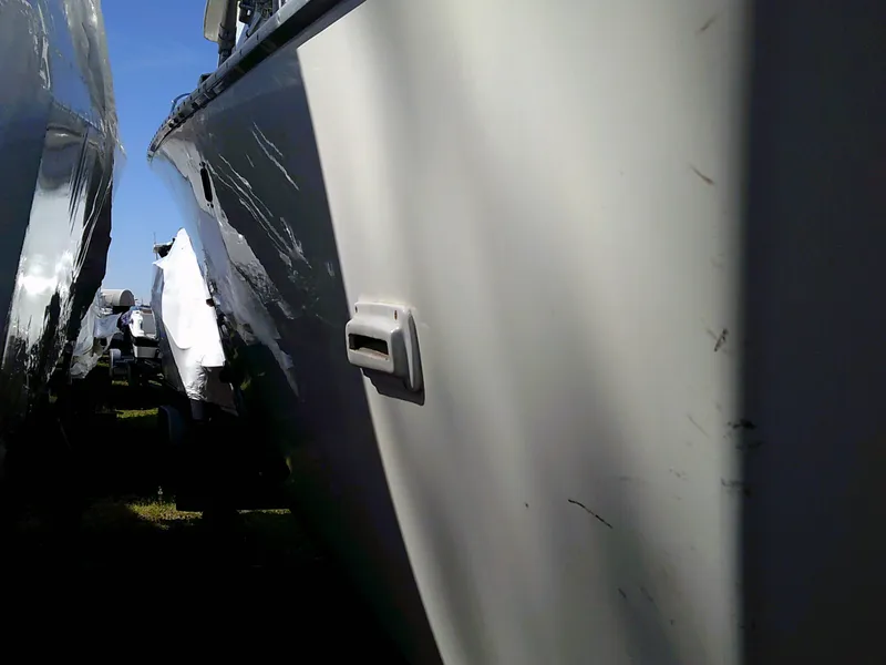 Slide: The Image of 1980 Bertram 28 Flybridge Cruiser boat hull close-up in storage. - 25