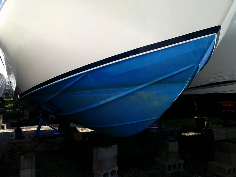 Slide: The Image of 1980 Bertram 28 Flybridge Cruiser boat hull on blocks. - 28