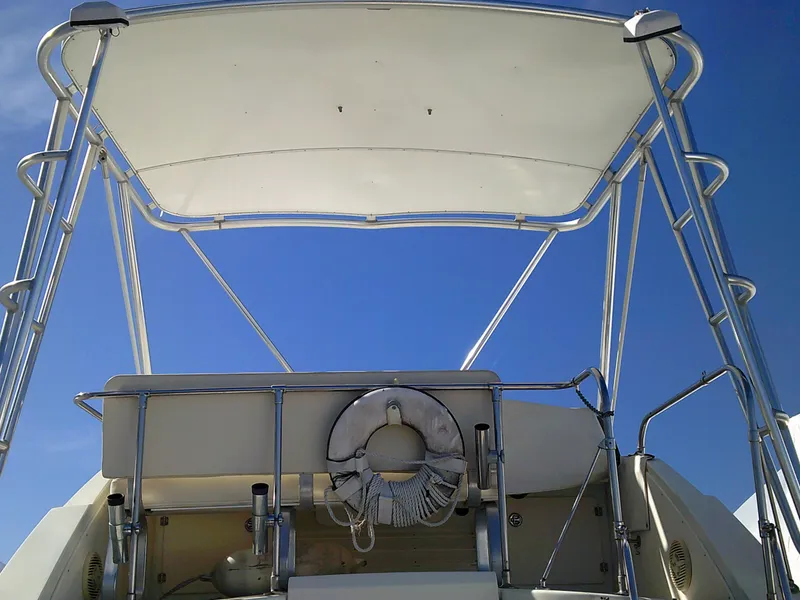 Slide: The Image of 1980 Bertram 28 Flybridge Cruiser with canopy and life preserver. - 3