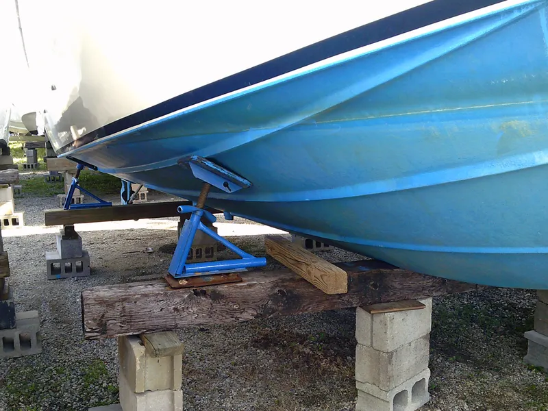Slide: The Image of 1980 Bertram 28 Flybridge Cruiser on blocks for maintenance. - 32