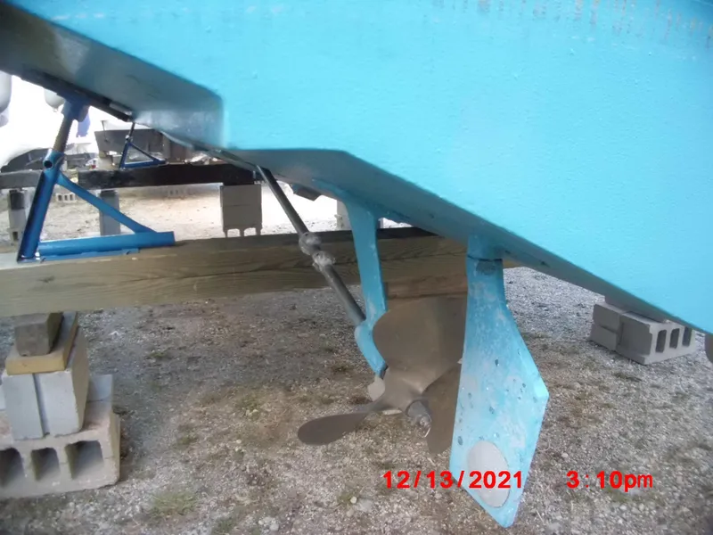 Slide: The Image of 1980 Bertram 28 Flybridge Cruiser propeller and rudder, dry docked for maintenance. - 35