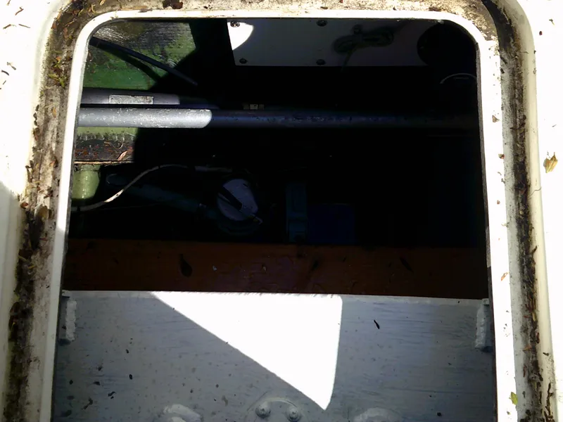 Slide: The Image of Open hatch of a 1980 Bertram 28 Flybridge Cruiser boat. - 7