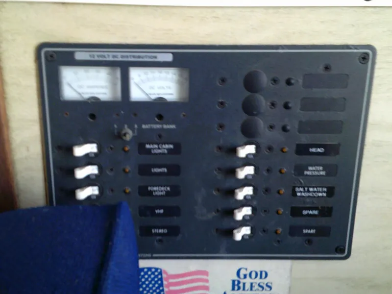 Slide: The Image of 1980 Bertram 28 Flybridge Cruiser electrical panel with switches and gauges. - 9