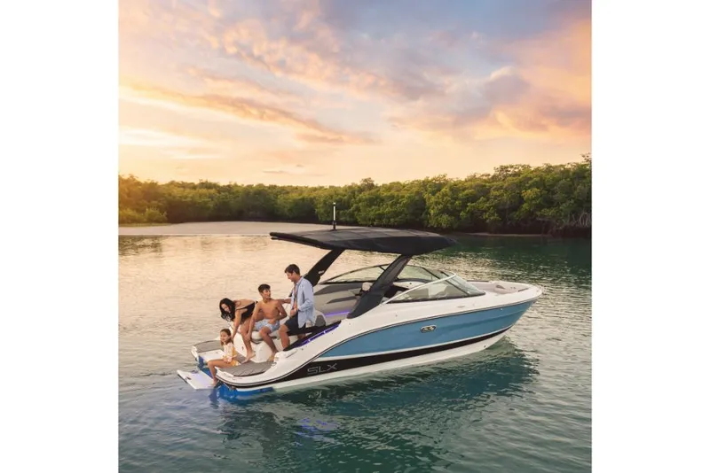 Slide: The Image of 2023 Sea Ray SLX 260 boat on water at sunset with people onboard. - 10