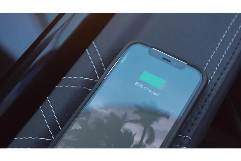 Slide: The Image of Smartphone charging on 2023 Sea Ray SLX 260 boat's stitched leather seat. - 17